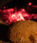 Lovely wholemeal and spelt roll being cooked in a wood-fired oven